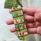Green tassel bookmark: Handmade polymer clay book mark with small books and plants